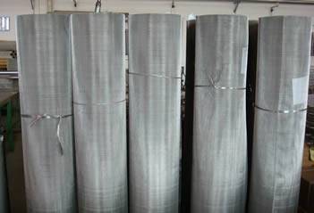 Five rolls of SS 304Q mesh on work shop tied with grey plastic tie wires 