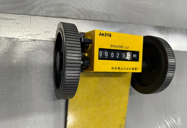 A yellow cart measuring the length of 316/316L stainless steel mesh