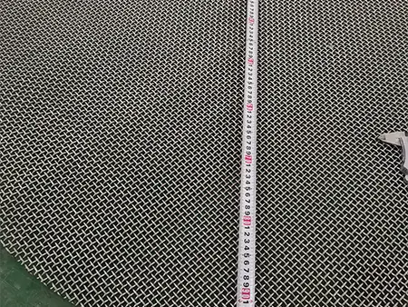 Measure the diameter of round stainless steel patterned weave piece with a tape measure