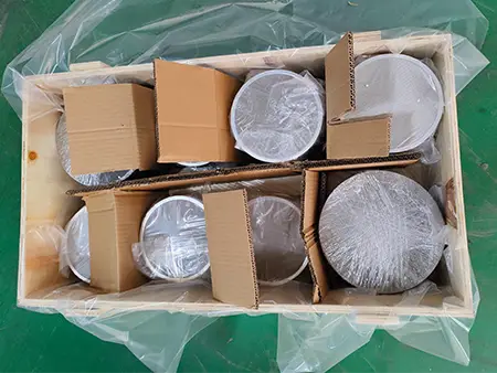 The stainless steel metal woven mesh is wrapped in plastic film and placed inside a carton