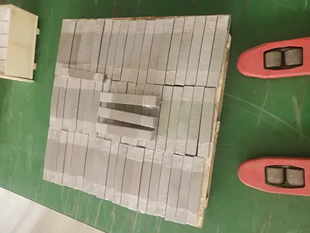 Rectangular stainless steel woven mesh sheet is placed in a plywood box.