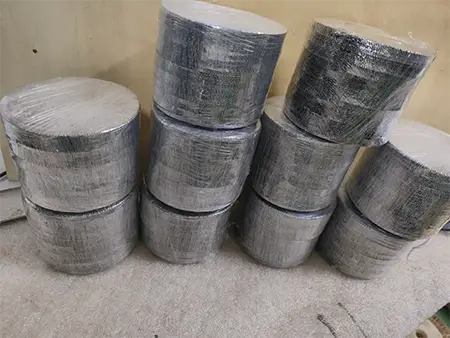 The rolled stainless steel metal woven mesh is wrapped in plastic film.