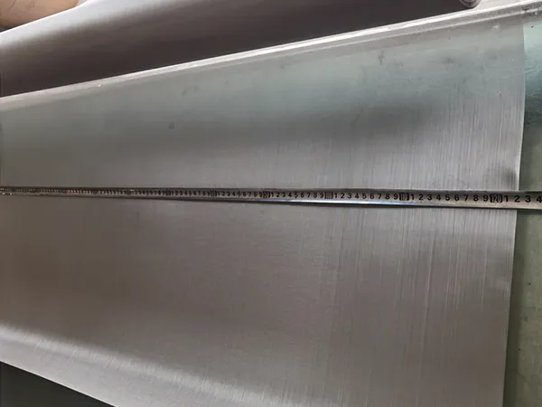 Measure the width of tensile bolting cloth with a tape measure.